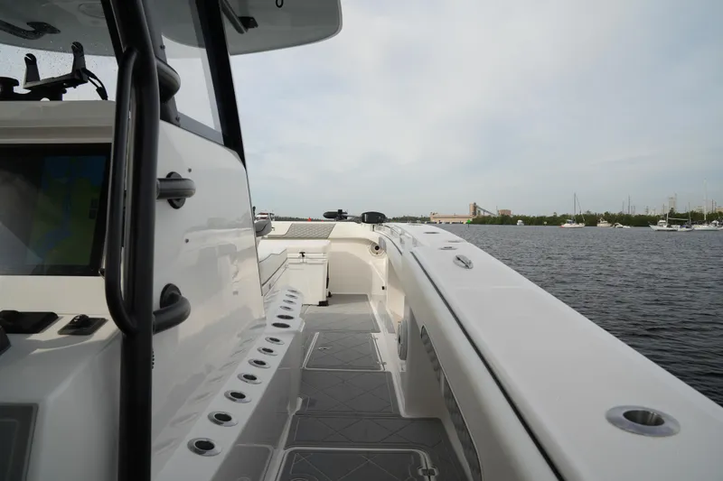 Slide: The Image of 2022 Invincible 46 Catamaran on water, showcasing sleek deck design and spacious layout. - 14