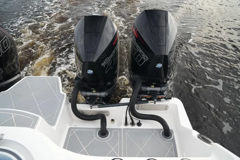 Slide: The Image of Twin outboard engines on a 2022 Invincible 46 Catamaran in motion. - 32