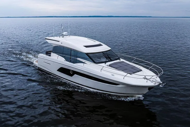 The Image of 2022 Prestige 520S yacht cruising on open water under cloudy skies. - 0