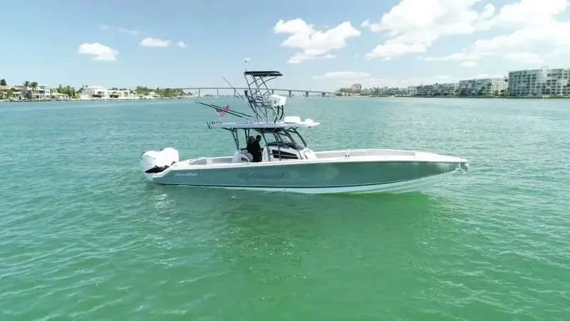 The Image of 2020 Nor-Tech 390 Sport Center Console boat on calm water under a clear sky. - 0