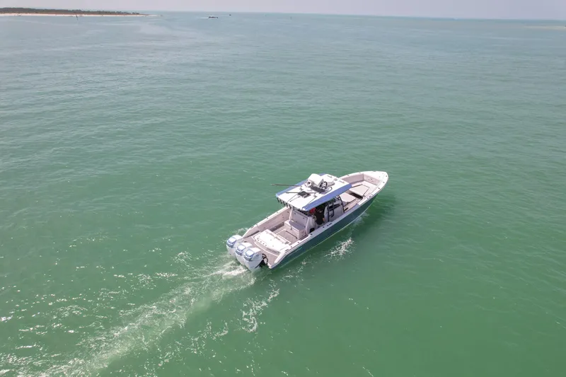 Slide: The Image of 2020 Nor-Tech 390 Sport Center Console cruising on open water. - 10