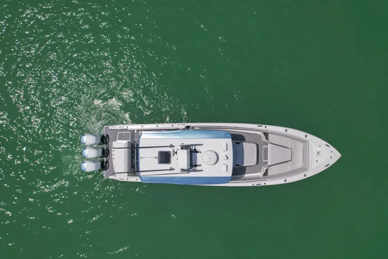 Slide: The Image of Aerial view of 2020 Nor-Tech 390 Sport Center Console boat on green water. - 13