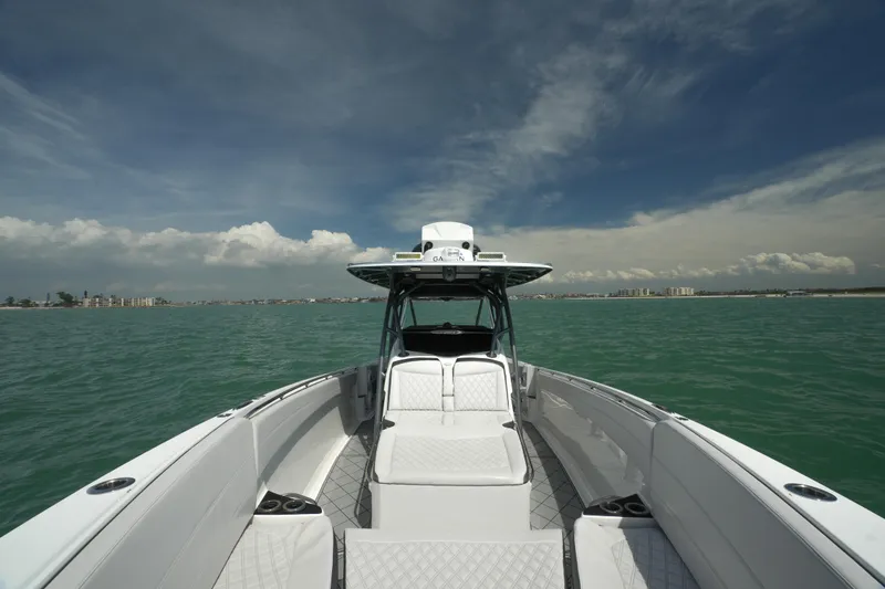 Slide: The Image of 2020 Nor-Tech 390 Sport Center Console boat on open water under a clear sky. - 15