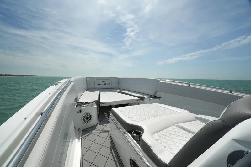 Slide: The Image of 2020 Nor-Tech 390 Sport Center Console boat with luxurious seating on open water. - 17