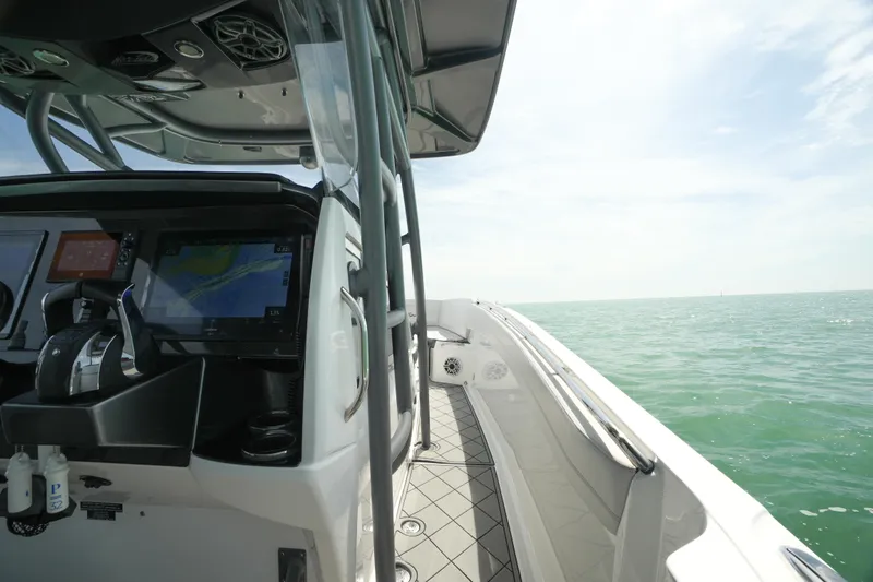 Slide: The Image of 2020 Nor-Tech 390 Sport Center Console on open water, featuring modern navigation equipment. - 18