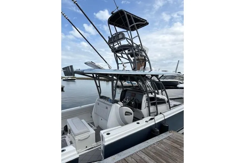 Slide: The Image of 2020 Nor-Tech 390 Sport Center Console boat docked, featuring a sleek design and fishing tower. - 2
