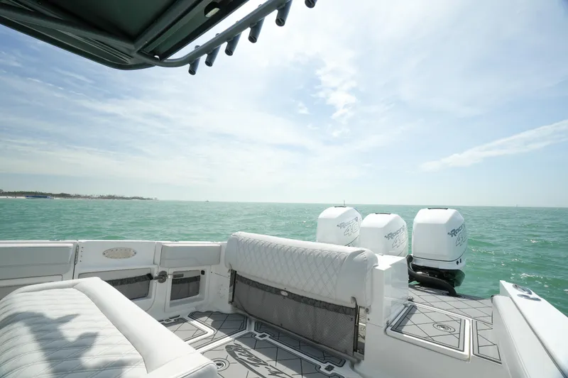 Slide: The Image of 2020 Nor-Tech 390 Sport Center Console on open water, featuring luxurious seating and powerful engines. - 25