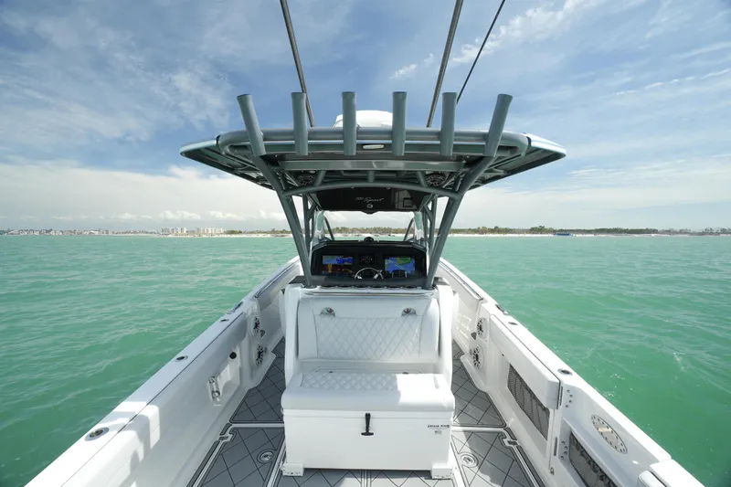 Slide: The Image of 2020 Nor-Tech 390 Sport Center Console boat on open water, featuring spacious deck and modern helm. - 29