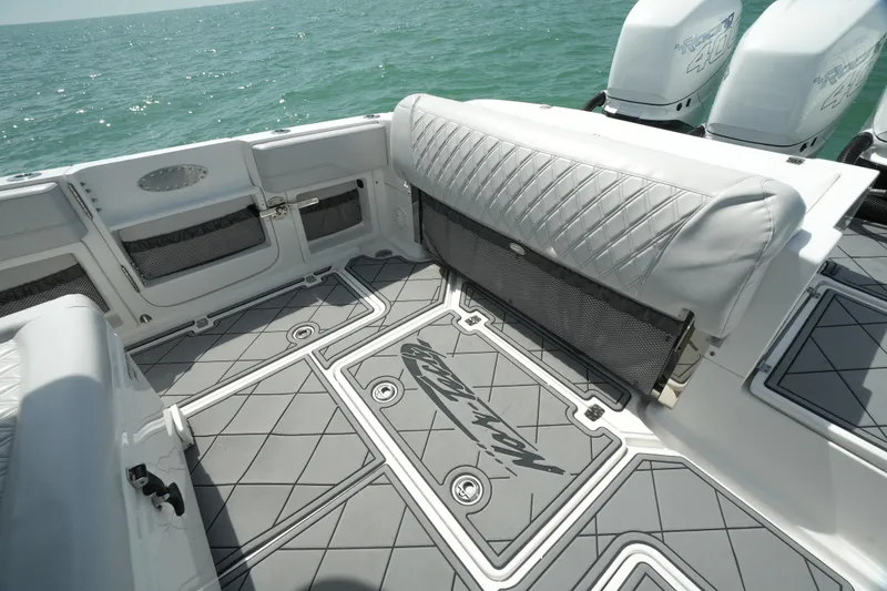 Slide: The Image of 2020 Nor-Tech 390 Sport Center Console boat interior with cushioned seating and ocean view. - 31