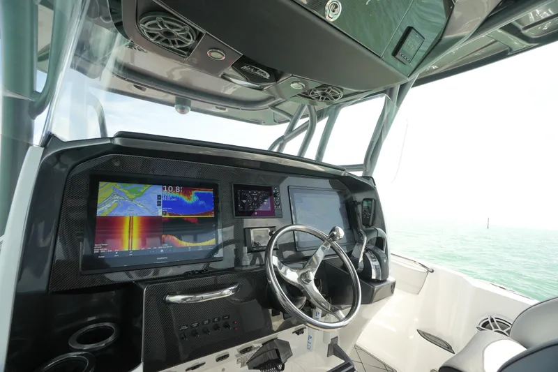 Slide: The Image of 2020 Nor-Tech 390 Sport Center Console dashboard with advanced navigation displays and controls. - 34