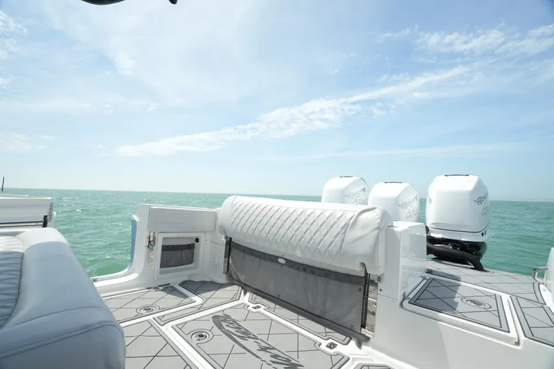 Slide: The Image of 2020 Nor-Tech 390 Sport Center Console boat with ocean view and triple outboard engines. - 37