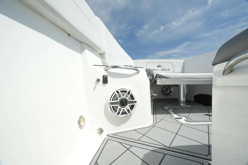 Slide: The Image of 2020 Nor-Tech 390 Sport Center Console interior with speaker and seating, under a clear sky. - 38