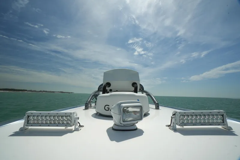 Slide: The Image of 2020 Nor-Tech 390 Sport Center Console boat on open water under a clear sky. - 41