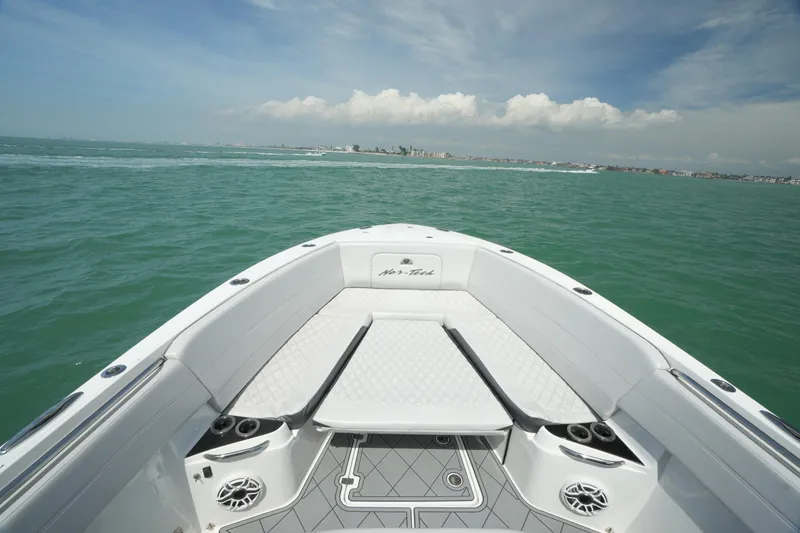 Slide: The Image of Nor-Tech 390 Sport Center Console 2020 on open water, showcasing sleek design and spacious deck. - 42