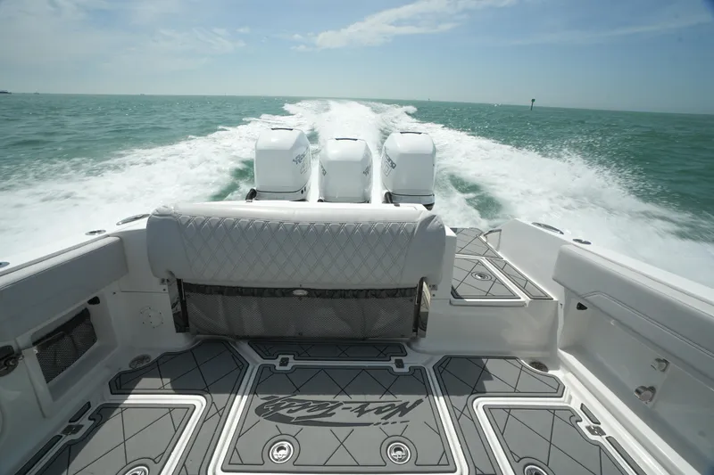 Slide: The Image of 2020 Nor-Tech 390 Sport Center Console speeding on open water, showcasing powerful engines. - 43