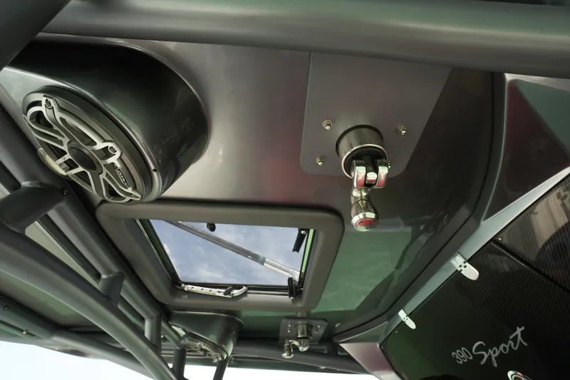 Slide: The Image of 2020 Nor-Tech 390 Sport Center Console interior with speaker and hatch details. - 44