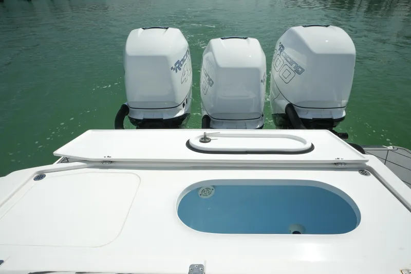 Slide: The Image of 2020 Nor-Tech 390 Sport Center Console with triple outboard engines on calm water. - 47