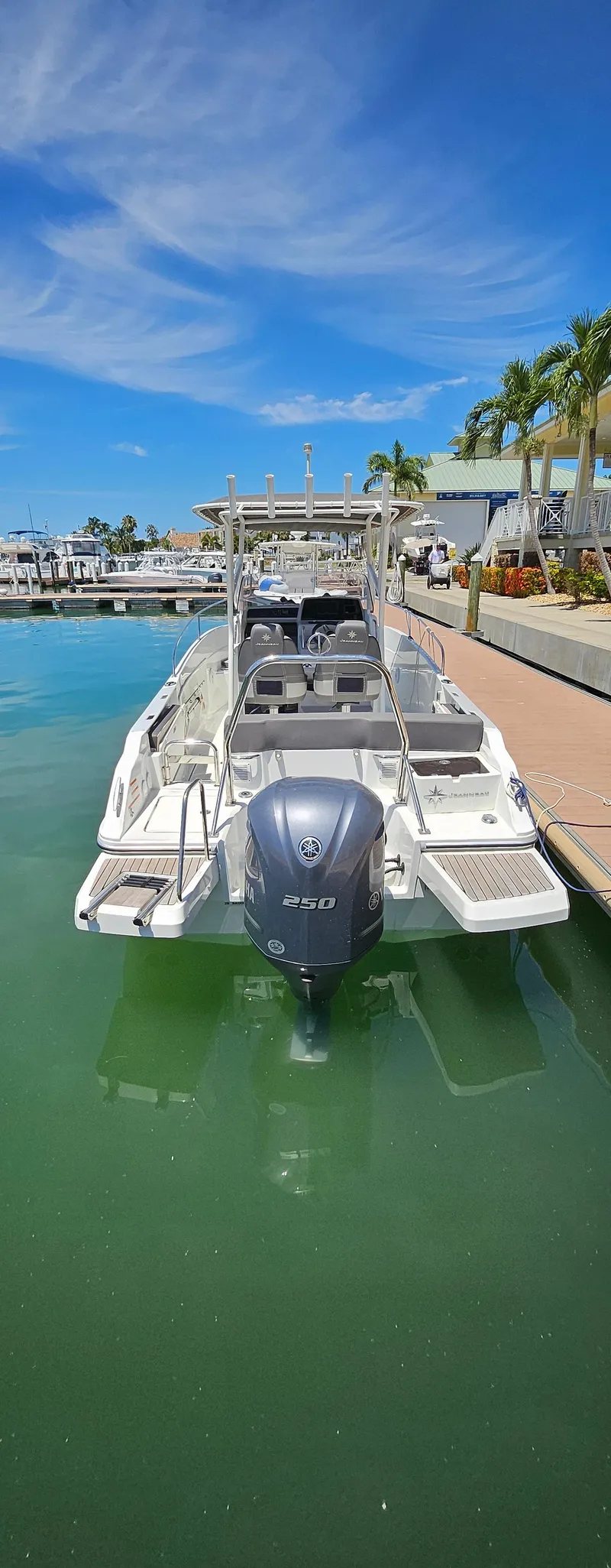 Slide: The Image of 2019 Jeanneau Leader 7.5 CC boat docked in a marina under a clear blue sky. - 21