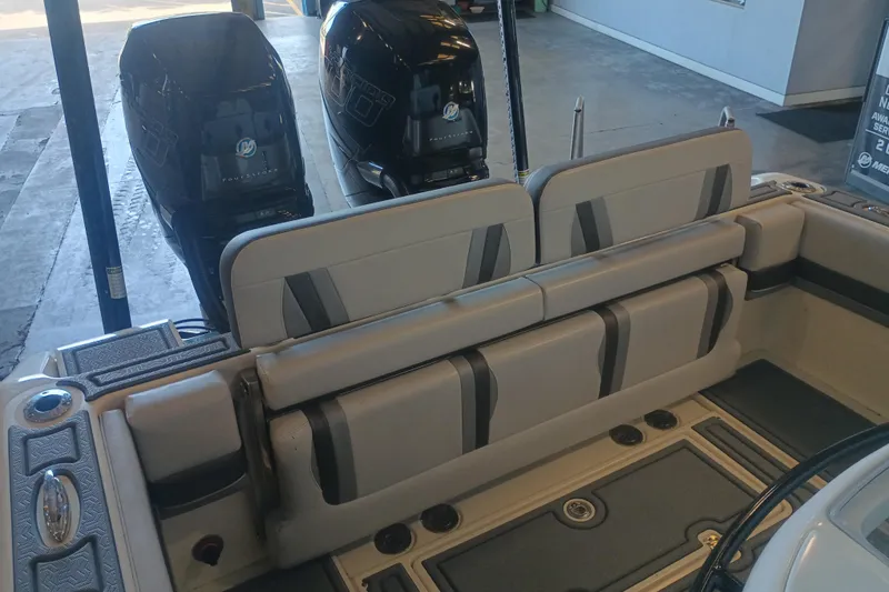 Slide: The Image of 2020 Blackwood 27 boat interior with dual outboard engines and cushioned seating. - 10