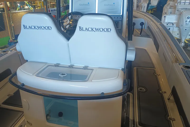 Slide: The Image of 2020 Blackwood 27 boat interior with dual seats and Garmin navigation system. - 13