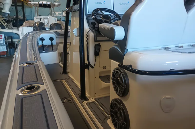 Slide: The Image of Interior view of a 2020 Blackwood 27 boat, featuring modern controls and seating. - 19