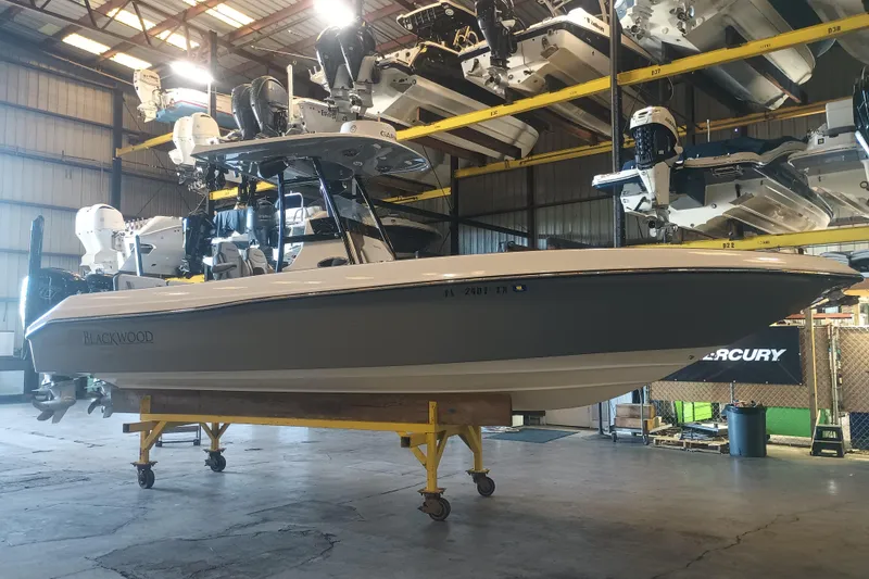 Slide: The Image of 2020 Blackwood 27 boat in storage facility, elevated on a stand. - 2
