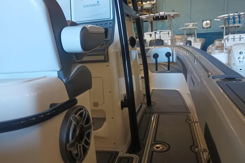 Slide: The Image of Interior view of a 2020 Blackwood 27 boat featuring modern seating and Garmin electronics. - 20