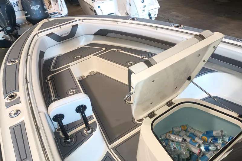 Slide: The Image of Open storage compartment on a 2020 Blackwood 27 boat, filled with drinks. - 21