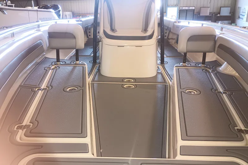 Slide: The Image of Interior view of a 2020 Blackwood 27 boat, featuring seating and deck layout. - 22