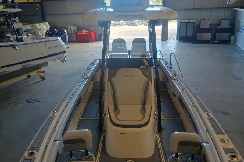 Slide: The Image of 2020 Blackwood 27 boat in a garage, featuring Garmin equipment and sleek seating. - 23