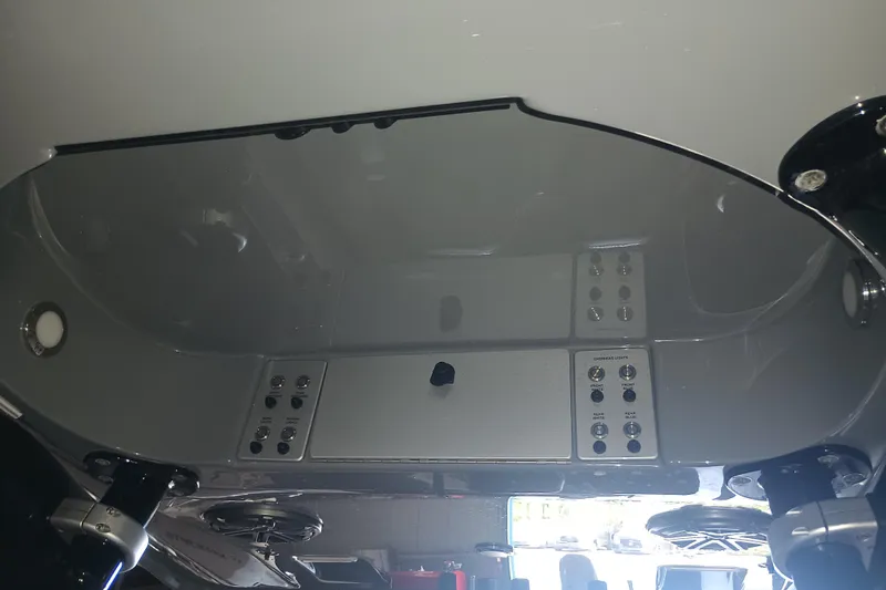 Slide: The Image of Control panel of a 2020 Blackwood 27 boat, featuring multiple switches and buttons. - 28