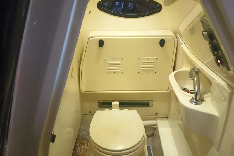 Slide: The Image of Interior of a 2020 Blackwood 27 boat bathroom with toilet and sink. - 29