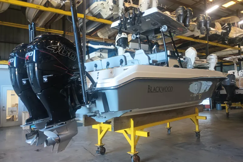Slide: The Image of 2020 Blackwood 27 boat with dual Mercury 400R engines in a showroom. - 3