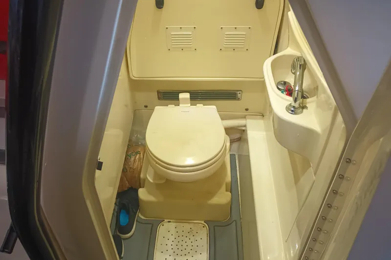 Slide: The Image of Compact marine bathroom in a 2020 Blackwood 27 boat, featuring a toilet and sink. - 30