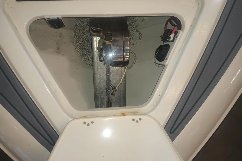 Slide: The Image of Anchor compartment of a 2020 Blackwood 27 boat, featuring chain and winch. - 32