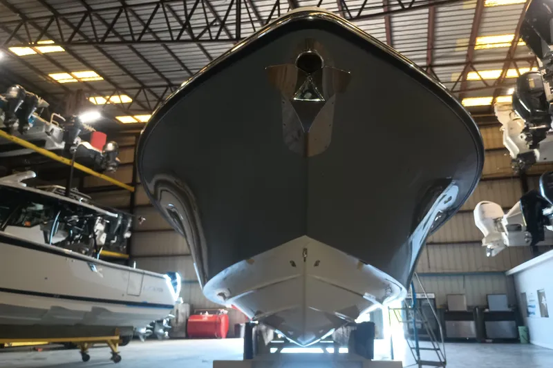 Slide: The Image of 2020 Blackwood 27 boat in a warehouse, showcasing its sleek hull design. - 6