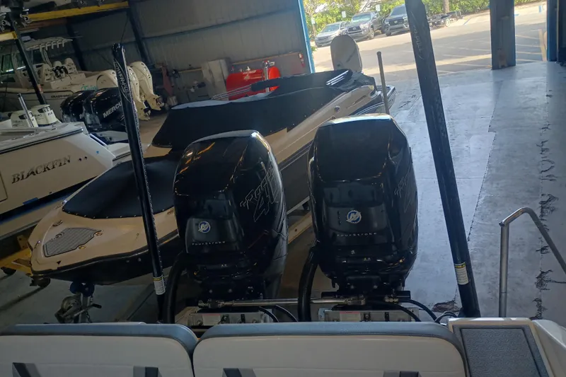 Slide: The Image of 2020 Blackwood 27 boat with dual Mercury outboard engines in a storage facility. - 8