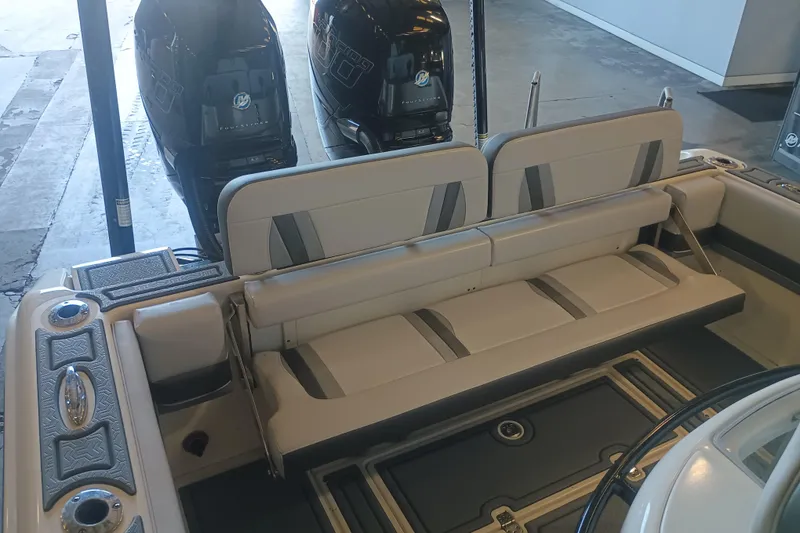 Slide: The Image of 2020 Blackwood 27 boat interior with dual outboard motors and cushioned seating. - 9