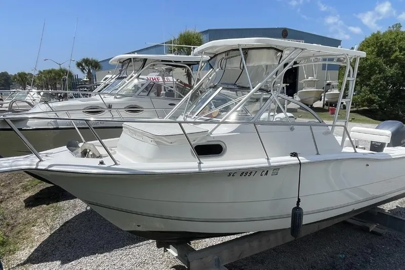 The Image of 2004 Sea Pro 238 Walk Around boat docked, featuring sleek design and spacious cabin. - 0