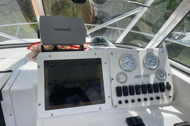 Slide: The Image of 2004 Sea Pro 238 Walk Around dashboard with Garmin GPS and instrument gauges. - 12