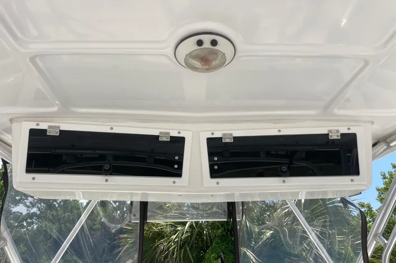 Slide: The Image of 2004 Sea Pro 238 Walk Around boat interior with overhead storage compartments. - 23
