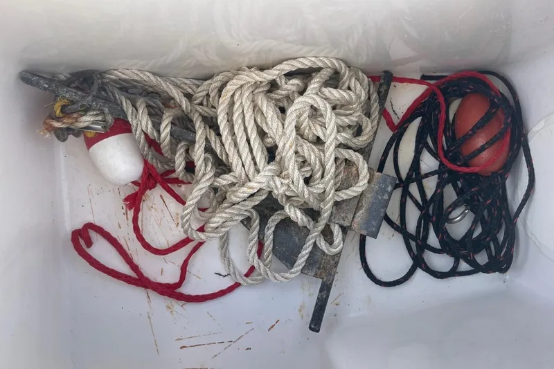 Slide: The Image of Ropes and buoys in a 2004 Sea Pro 238 Walk Around boat compartment. - 30