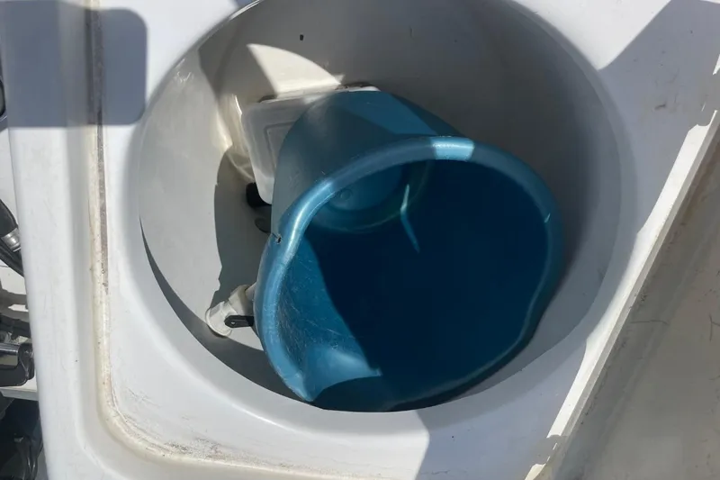 Slide: The Image of Blue bucket inside a compartment on a 2004 Sea Pro 238 Walk Around boat. - 33