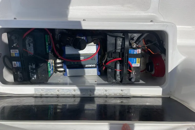 Slide: The Image of 2004 Sea Pro 238 Walk Around boat battery compartment with wiring and components. - 35