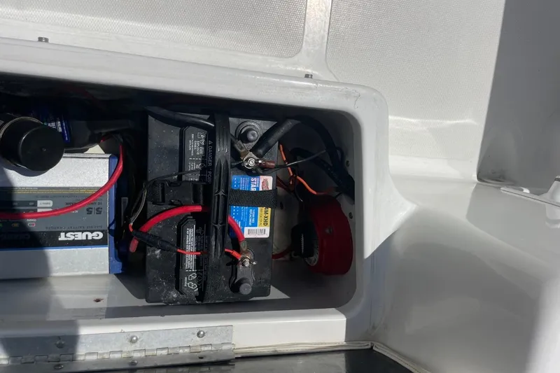 Slide: The Image of Battery compartment of 2004 Sea Pro 238 Walk Around boat with wiring and charger. - 36