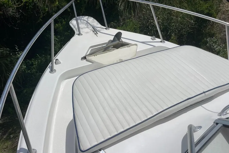 Slide: The Image of 2004 Sea Pro 238 Walk Around boat deck with cushioned seating and railing. - 38