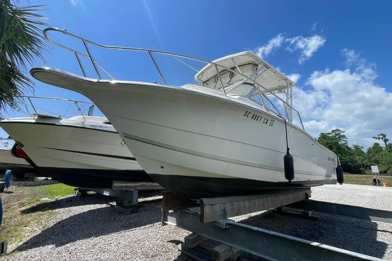 Slide: The Image of 2004 Sea Pro 238 Walk Around boat on trailer under clear blue sky. - 4