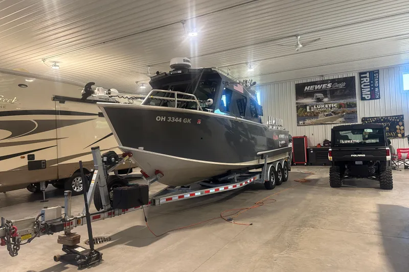 The Image of 2022 Hewescraft 270 Alaskan Hardtop boat on trailer in indoor storage facility. - 1