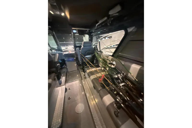 Slide: The Image of Interior of 2022 Hewescraft 270 Alaskan Hardtop with fishing rods and seating. - 10