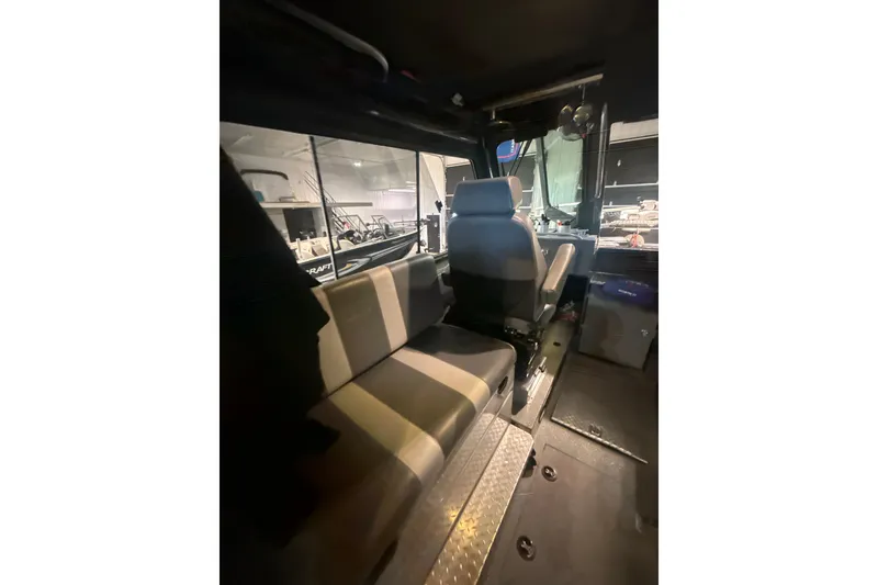 Slide: The Image of Interior of 2022 Hewescraft 270 Alaskan Hardtop, featuring seating and helm area. - 11
